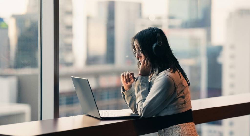 Woman working near city window